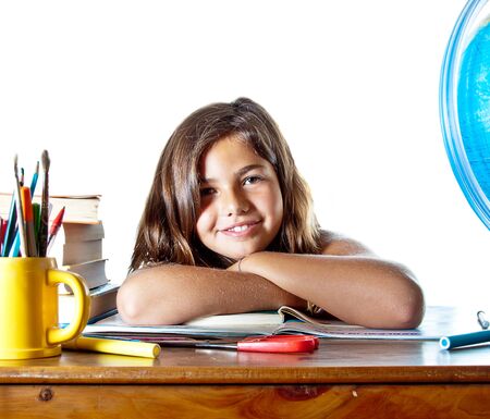 Little girl wakes up after sleeping on her homework. Isolated on white background with plenty of copyspace.の写真素材