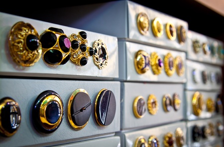 Boxes of jewel-like vintage buttons for sale in a haberdashery shop  Shallow depth of field の写真素材