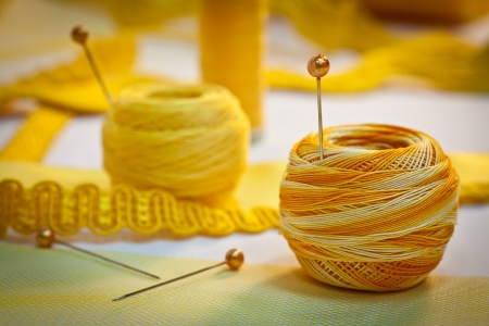 Yellow sewing and embroidery thread with pins, ribbons, haberdashery  の写真素材