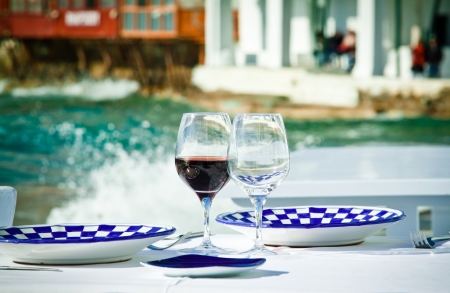 A table ready for a meal by the sea in Little Venice, Mykonos, Greece.の写真素材