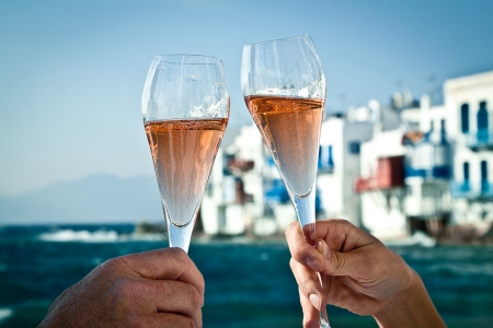 A romantic toast by the sea in Greece の写真素材