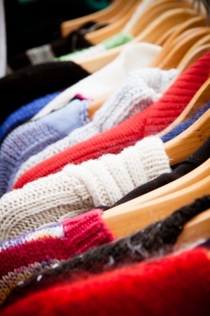 Close-up on a rack of second-hand jumpers and cardigans at a market in London  recession bargains の写真素材