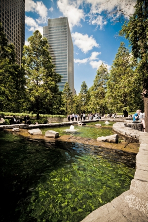 London, 3 June 2011: office workers enjoying the gorgeous summer weather at lunchtime, in London's financial district at the Docklands. Jubilee Park, Canary Wharf, Docklands, London.のeditorial素材