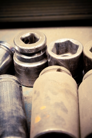 Close up on spare sockets and nuts in an auto repair shop  Slight cross-process treatment for an industrial feel の写真素材