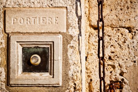 RIng the doorbell for the concierge  A buzzer on an old stone  の写真素材