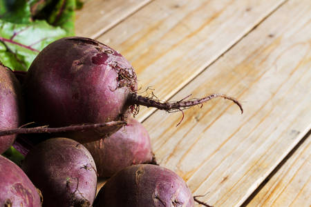 Close-up on fresh, organic raw beetroot against a wooden background. Plenty of copy space.の写真素材