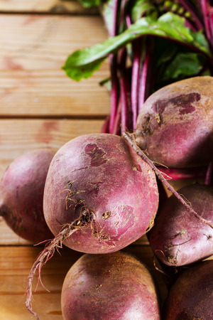 Fresh, organic raw beetroot against a wooden background. Plenty of copy space.の写真素材