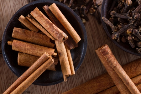 Assorted spices for food and decoration: cinnamon sticks and cloves.