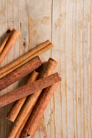 Spices series: cinnamon sticks against rustic wooden background. Copy space.の写真素材