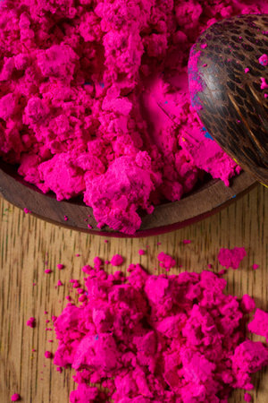 Colorful, finely powdered Indian pigments. Closeup on the magenta with a measuring spoon.の写真素材