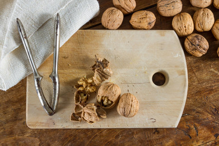 Autumnal fruits: walnuts against wooden rustic background.の写真素材