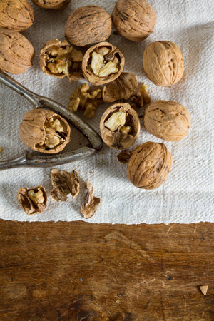 Autumnal fruits: walnuts against wooden rustic background.の写真素材