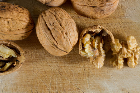 Autumnal fruits: walnuts against wooden rustic background.の写真素材