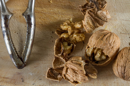 Autumnal fruits: walnuts against wooden rustic background.