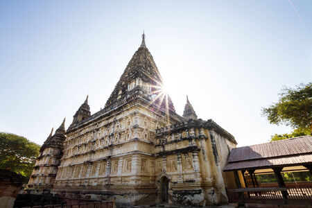 Sun starburst peeking from a temple buiding in Bagan, Myanmar (Burma)