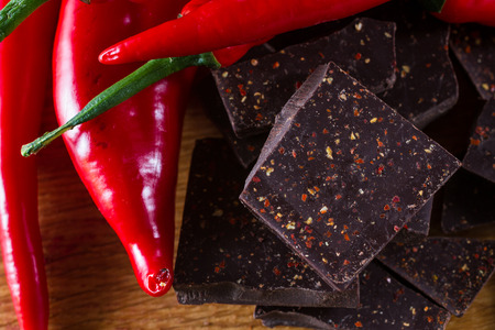 Delicious, spicy and hot dark chocolate with red chilli peppers.の写真素材