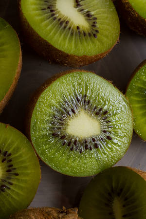 Close up on ripe half kiwi fruits one a grey plate. Healthy eating.の写真素材