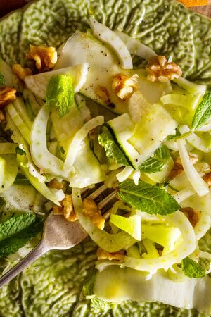 Healthy eating: raw fennel salad with walnuts, raw courgettes, mint leaves and lemon juice. Zesty, fresh, summery and light food. Perfect for a diet.の写真素材