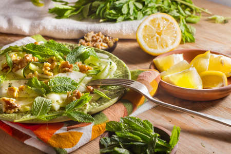Healthy eating: raw fennel salad with walnuts, raw courgettes, mint leaves and lemon juice. Zesty, fresh, summery and light food. Perfect for a diet.の写真素材
