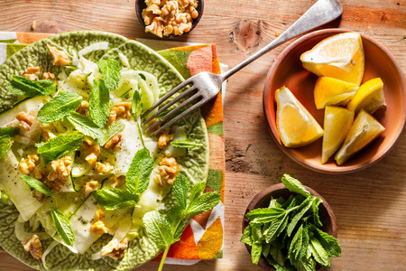 Healthy eating: raw fennel salad with walnuts, raw courgettes, mint leaves and lemon juice. Zesty, fresh, summery and light food. Perfect for a diet.の写真素材