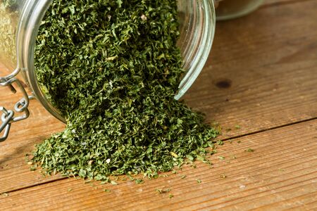Middle Eastern cuisine: a jar of dried parsley with other herbs in the background.の写真素材
