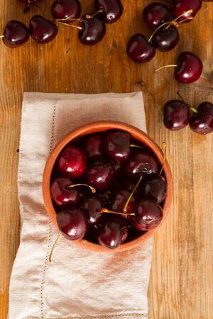 Ripe cherries on rustic wooden backgroundの写真素材