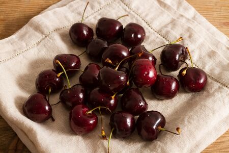Ripe cherries on rustic wooden backgroundの写真素材