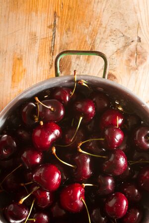 Ripe cherries on rustic wooden backgroundの写真素材