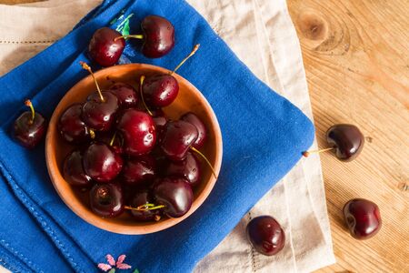 Ripe cherries on rustic wooden backgroundの写真素材