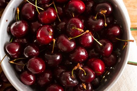 Ripe cherries on rustic wooden backgroundの写真素材