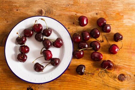 Ripe cherries on rustic wooden backgroundの写真素材
