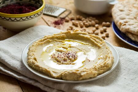 Middle Eastern cuisine: freshly made hummous, a spread made from chickpeas and seasoned with sumac and oil. Served with flat bread.の写真素材