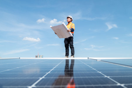 Engineers and technicians check drawings for installing solar cell panels on the roof. alternative energy energy from the sunの写真素材