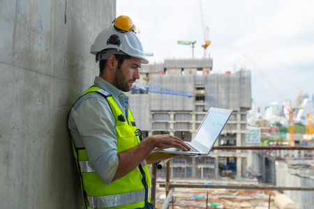 architect engineer designing a structure holding tablet, walkie talkie, drawing