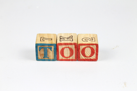 Wooden alphabet blocks spelling out TOO on white background. Colorfull wooden alphabet blocks.の写真素材