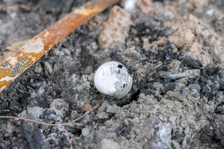 Aluminium bottle cap burned. Eviroment waste concept.