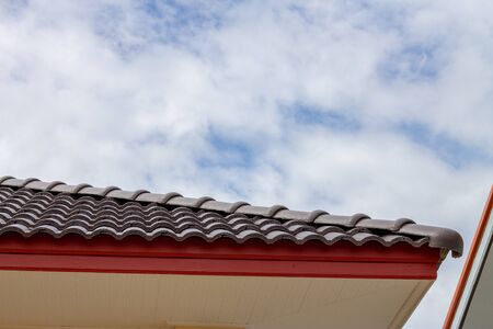 The gable roof with the sky with clouds background.