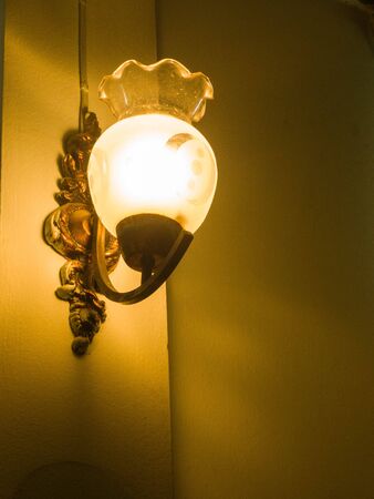 The old electric  lamp on the concrete wall の写真素材