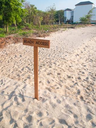 A sign post of beach access on the beach の写真素材