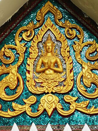 The Thai pattern of Angel blessing with heads of serpents are decorated on a triangular gable of a church.の写真素材