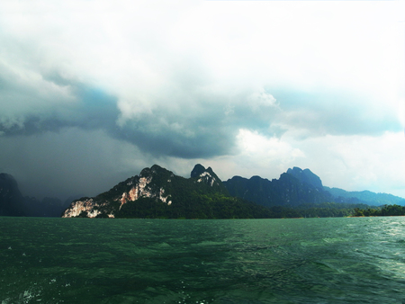 A big reservoir surrounded by ranges of mountains in Surat Thani , Thailand.の写真素材
