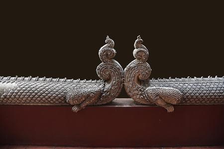 The sculptures in Lanna style of the ancient creatures of Mom. Mom is a powerful animal statue  created for protecting the entrance of temples in the North of Thailand.の写真素材