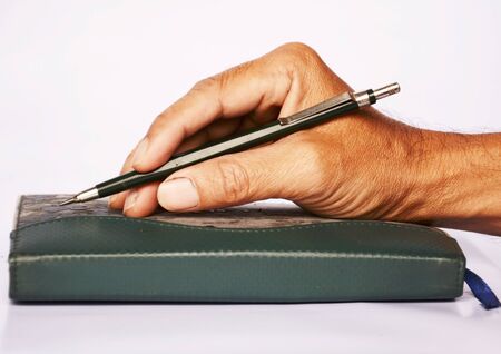 hand and pencil old bookの写真素材