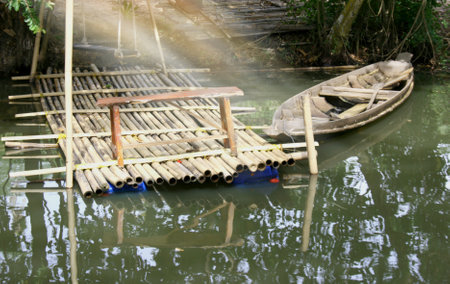 old boat wooden in lake  and sunlightの写真素材