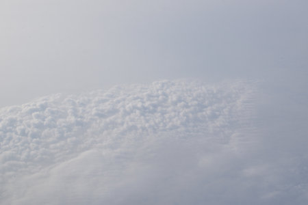 Sky and fluffy clouds above the sky from the plane window.