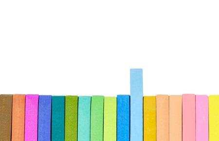Colorful chalk pastel (brown, orange, purple, green, blue, pink and yellow) on white background.の写真素材
