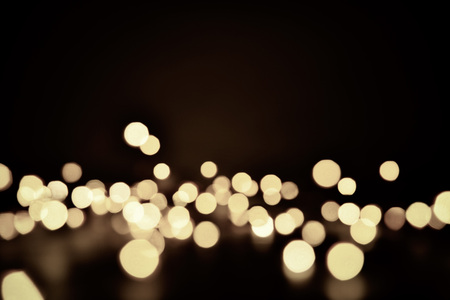Abstract bokeh background of defocused lights. Merry Christmas and New Year background. Holiday glowing background and wallpaper. Blurred Bokeh.の写真素材