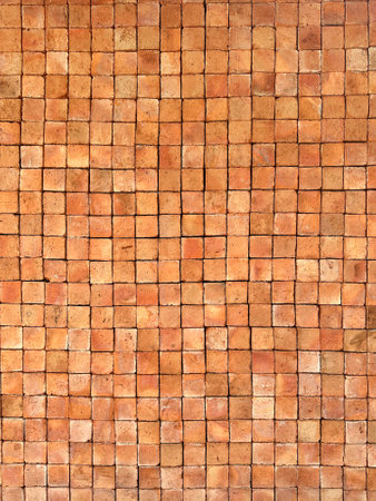 Orange and brown brick wall background texture and wallpaper. Exterior wall decoration and design.の写真素材
