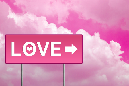 love on pink road sign with skyの写真素材