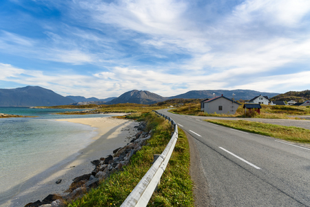 Asphalt road along the beach and sea with blue sky, fjord Norwayの写真素材